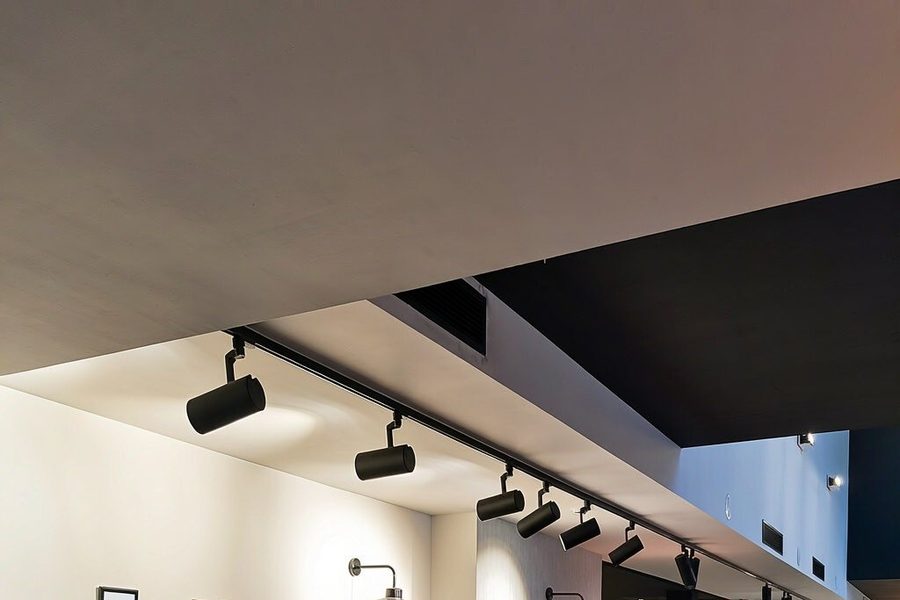 Track lighting installation reference — cylindrical spotlights on a ceiling track