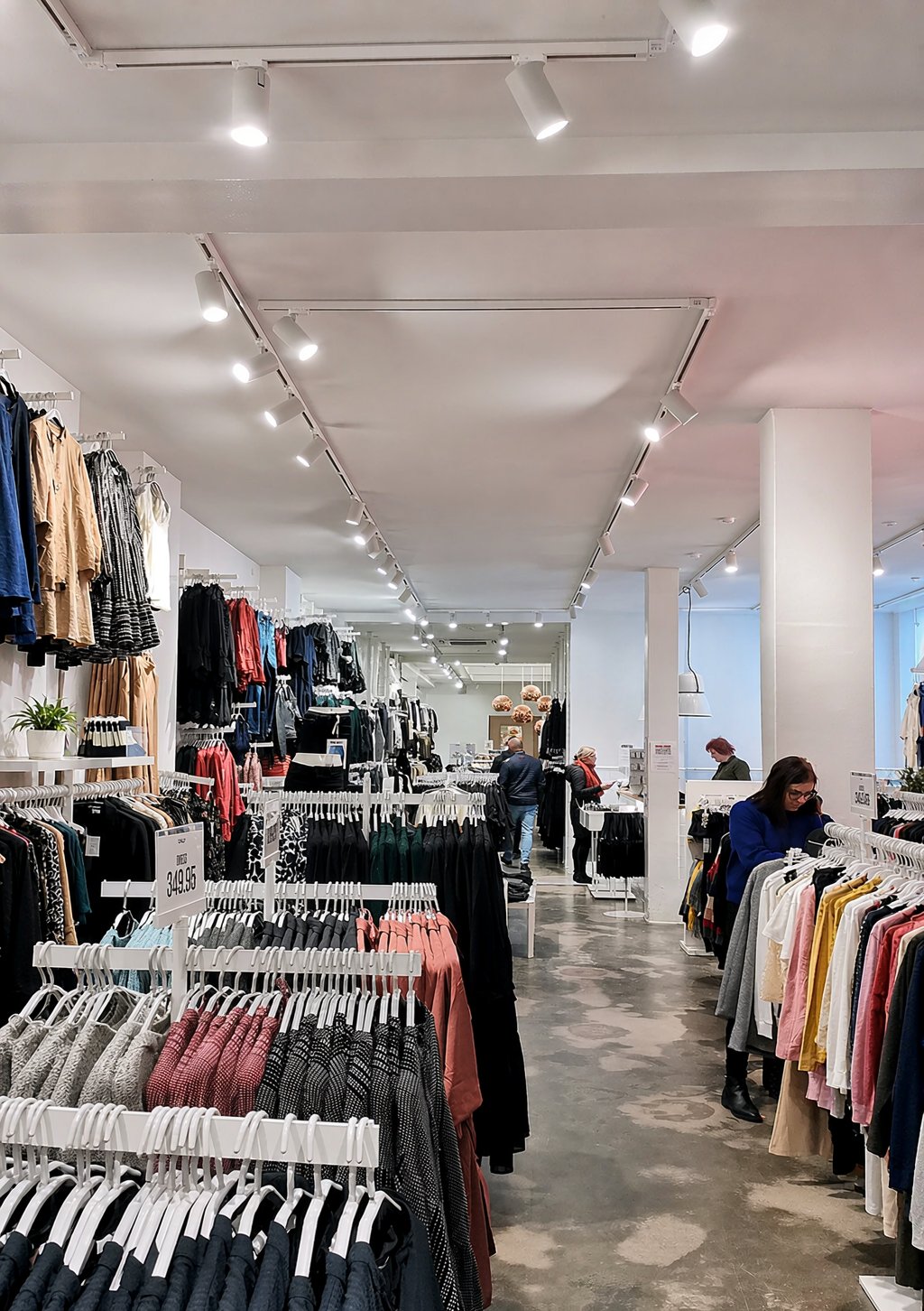 Clothing store — ceiling track across merchandising zones
